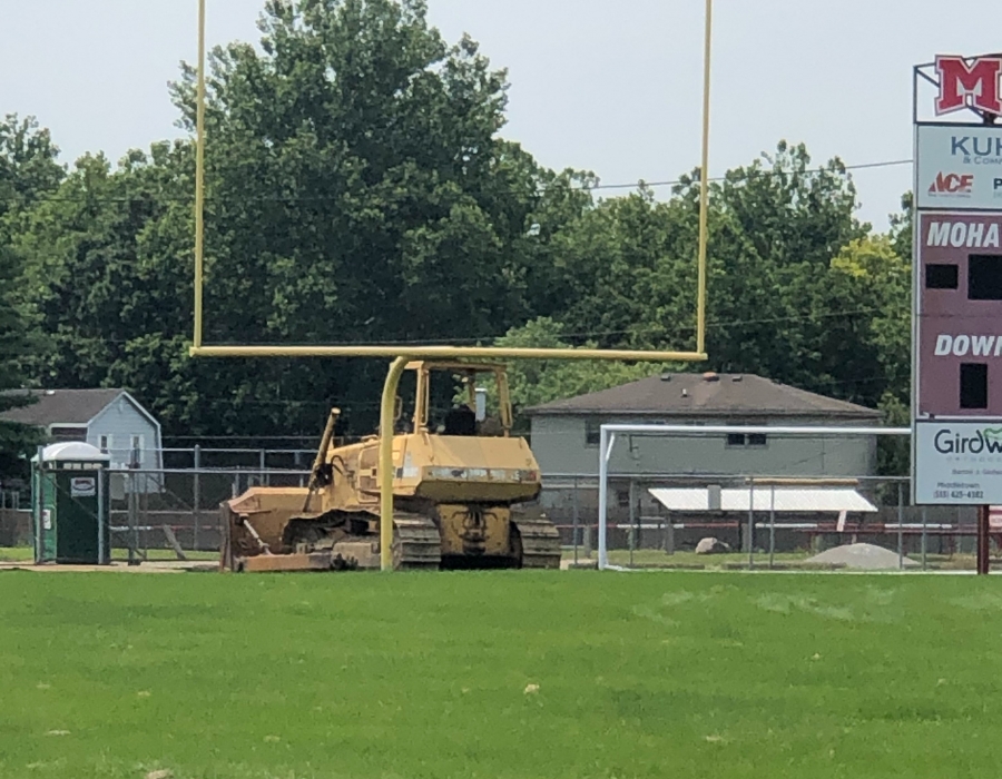 An excavator is present on July 22, 2021 to begin breaking ground for the new turf field.